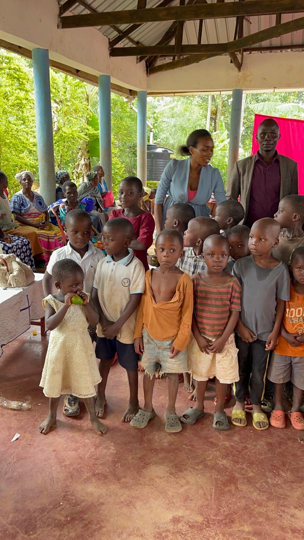Group of young children standing together under an open-sided shelter